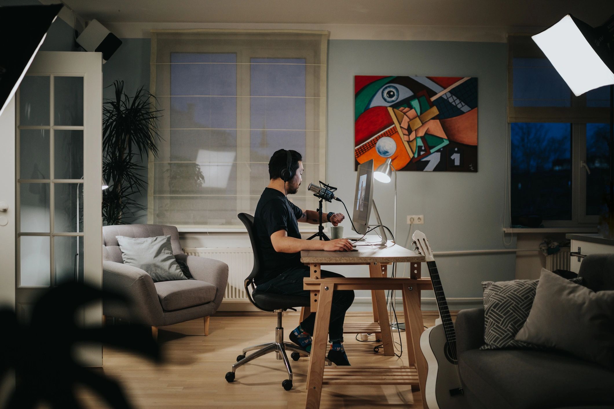 Creator working in a modern studio workspace with screens and equipment